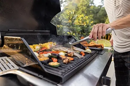 Customer using new grill parts in the backyard